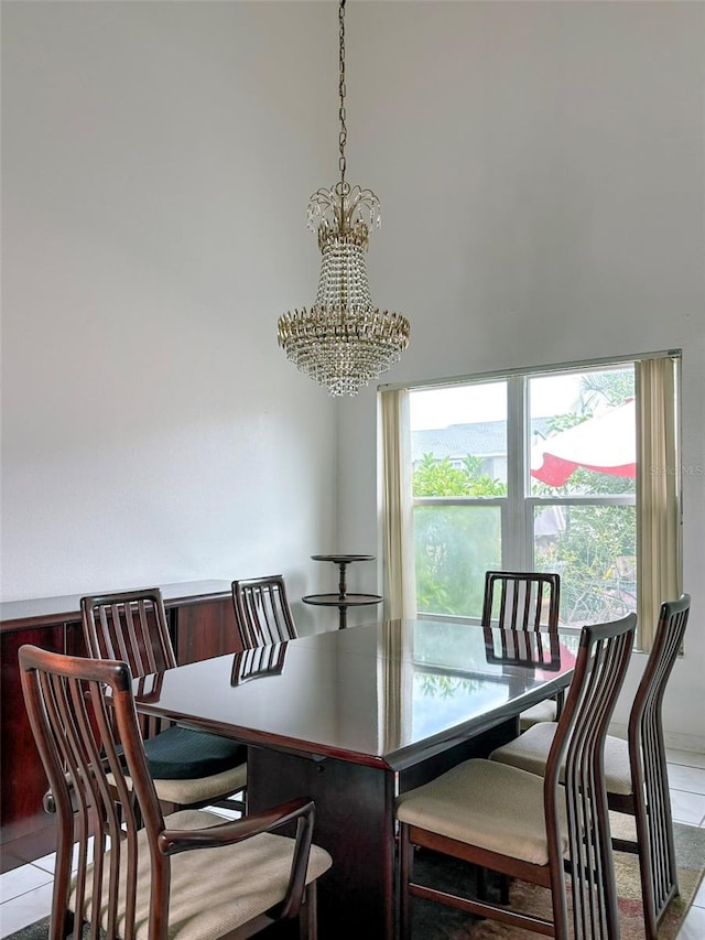 tiled dining space with an inviting chandelier