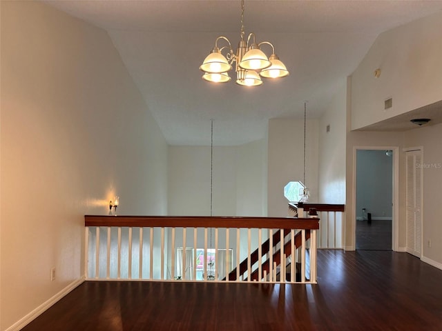 hall featuring a notable chandelier, high vaulted ceiling, and dark hardwood / wood-style floors