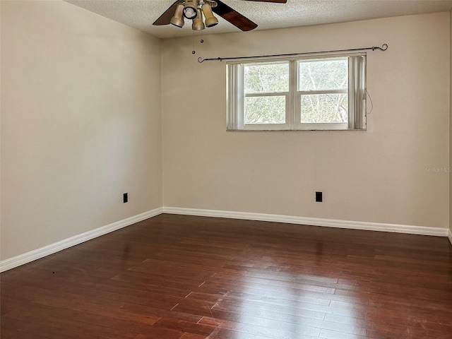 spare room with a textured ceiling, ceiling fan, and dark wood-type flooring