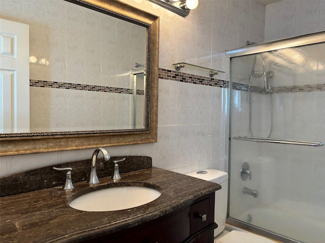 bathroom featuring tile walls, toilet, backsplash, and vanity with extensive cabinet space