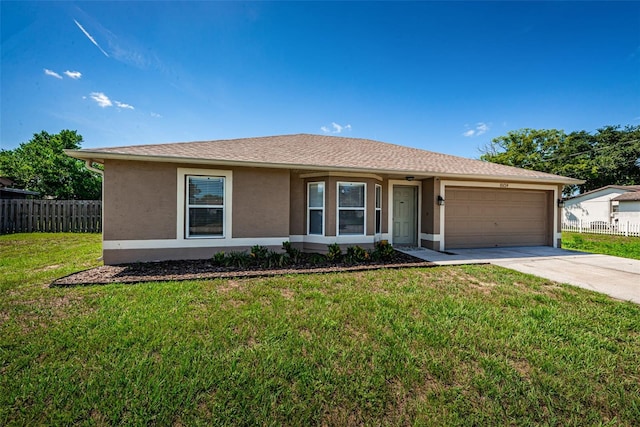 single story home featuring a front lawn and a garage