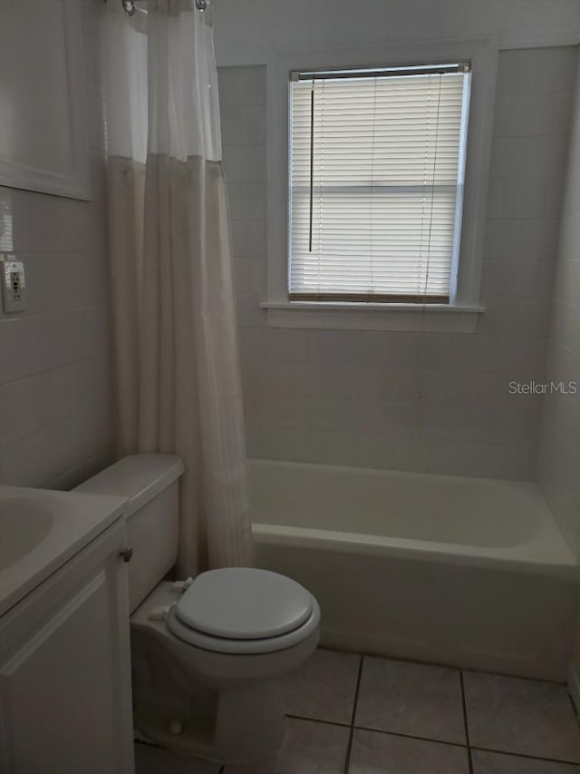 full bathroom with tile patterned floors, vanity, toilet, and shower / bathtub combination with curtain