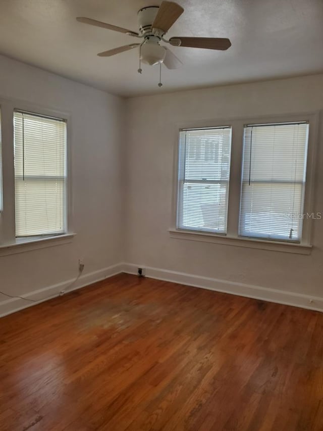 empty room featuring hardwood / wood-style flooring and ceiling fan