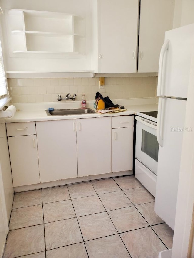 kitchen featuring sink, light tile patterned flooring, white appliances, decorative backsplash, and white cabinets