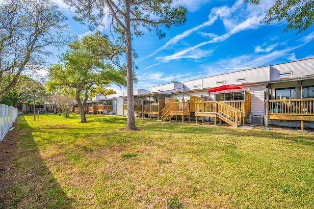 view of yard featuring a wooden deck and central AC