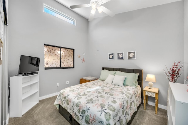 bedroom featuring ceiling fan and dark carpet