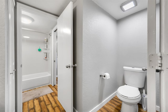 bathroom featuring shower / bath combination, toilet, and hardwood / wood-style floors