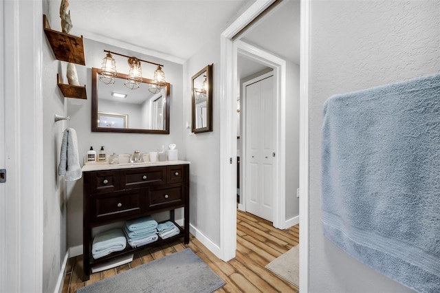 bathroom featuring hardwood / wood-style floors and vanity with extensive cabinet space