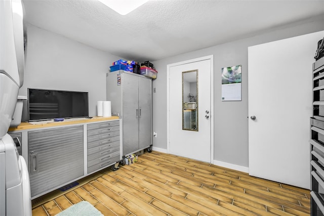 interior space featuring a textured ceiling and light hardwood / wood-style floors