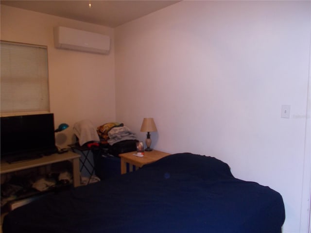 bedroom featuring a wall mounted AC