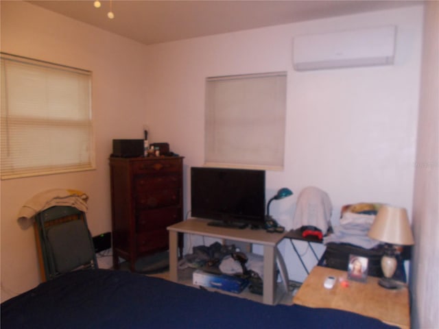 bedroom featuring a wall mounted AC