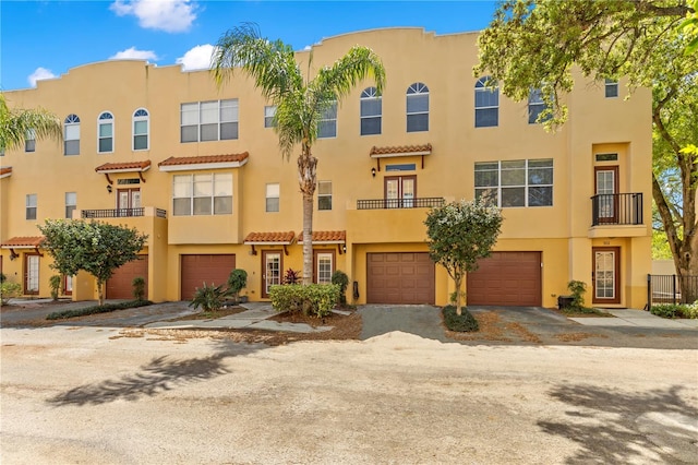 view of front of house with a garage and a balcony