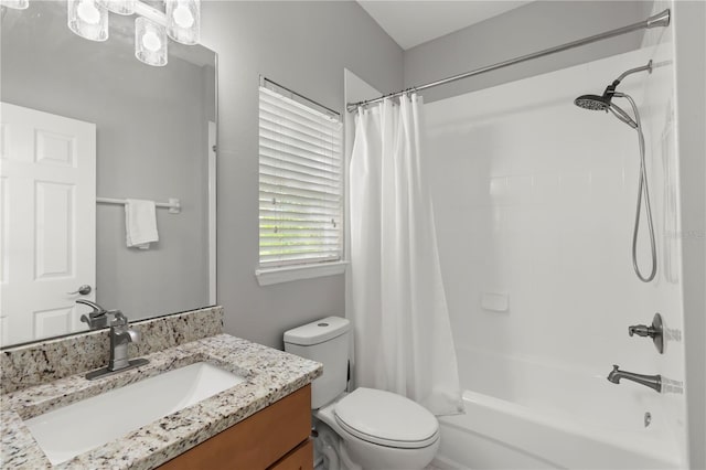 full bathroom featuring shower / bath combo, vanity, and toilet