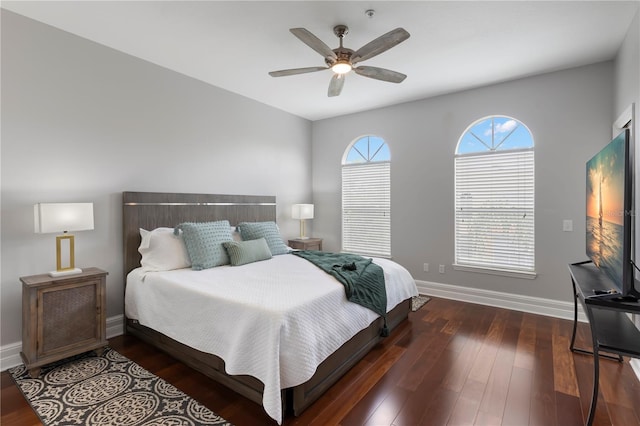 bedroom with dark hardwood / wood-style flooring and ceiling fan