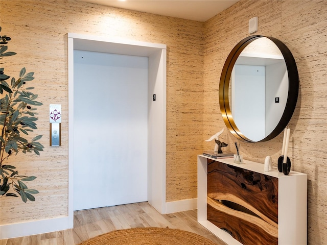 bathroom featuring vanity, elevator, and hardwood / wood-style flooring