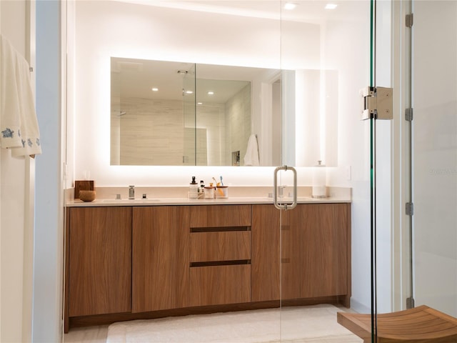 bathroom with dual bowl vanity, tile floors, and a shower with shower door