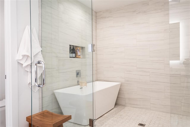 bathroom featuring tile walls, a shower with door, and tile floors