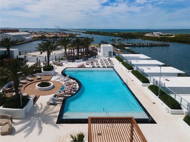 view of pool with a water view and a patio area