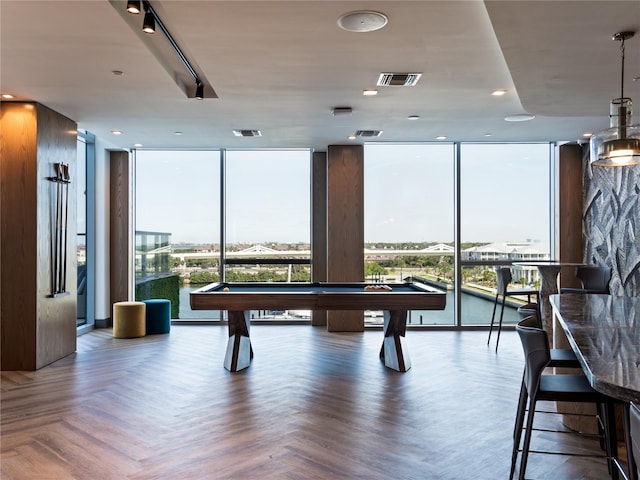 game room featuring a wall of windows, pool table, and dark parquet flooring