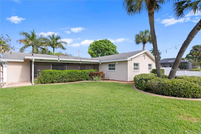 rear view of property with a yard