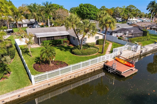 view of dock with a water view and a yard