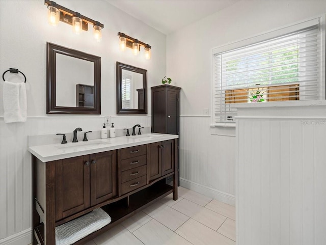 bathroom featuring dual vanity and tile floors