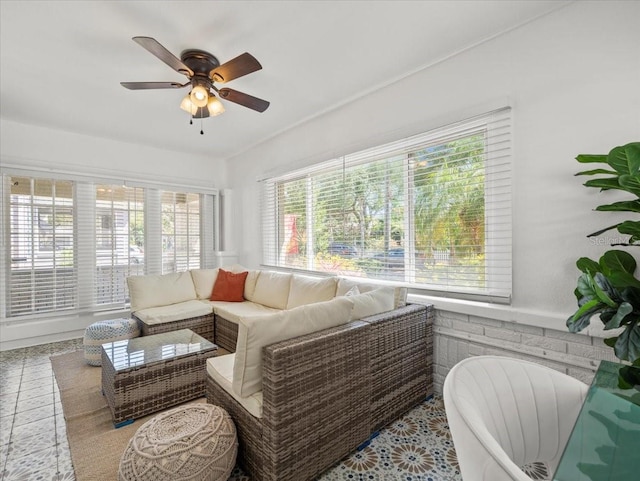 living room featuring light tile floors and ceiling fan