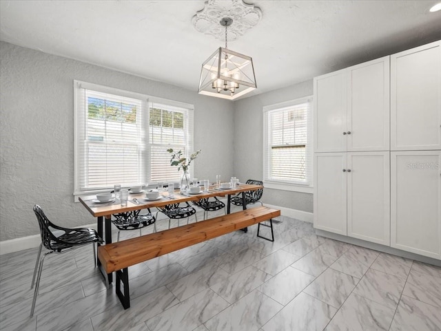 rec room featuring a chandelier, plenty of natural light, and light tile floors