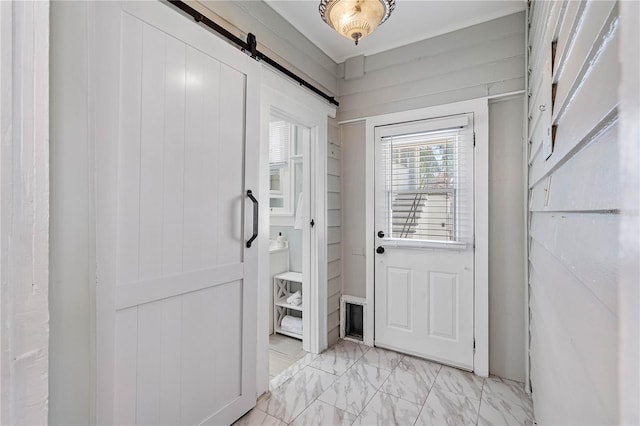 doorway with a barn door and light tile floors