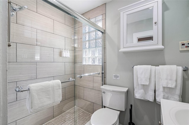 bathroom featuring walk in shower and toilet