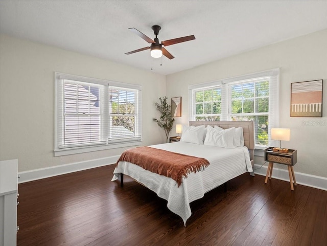 bedroom with dark hardwood / wood-style flooring and ceiling fan