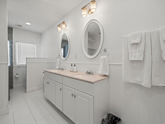 bathroom with double sink vanity and tile flooring