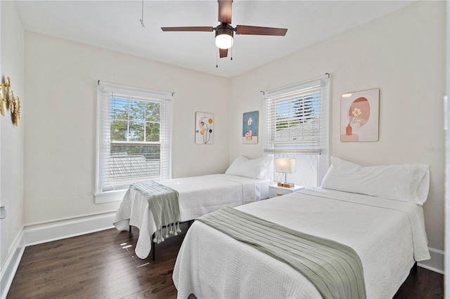 bedroom with dark hardwood / wood-style floors and ceiling fan