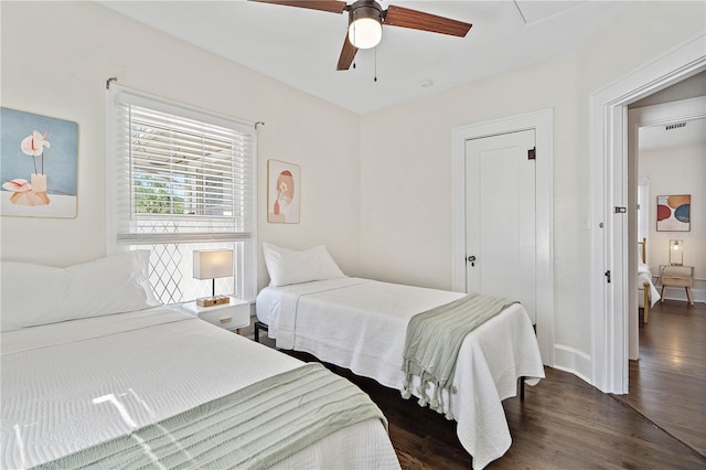 bedroom featuring dark hardwood / wood-style floors and ceiling fan