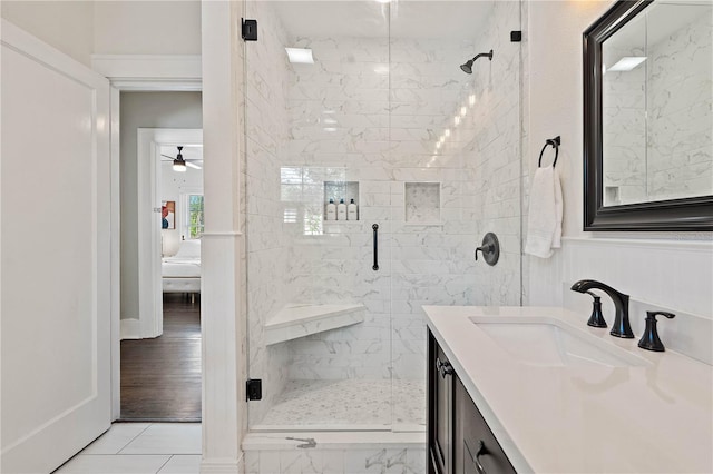 bathroom with an enclosed shower, tile floors, ceiling fan, and vanity