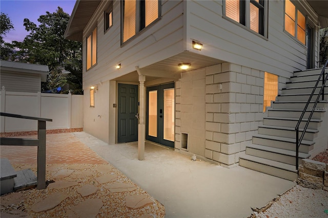 exterior entry at dusk featuring a patio area