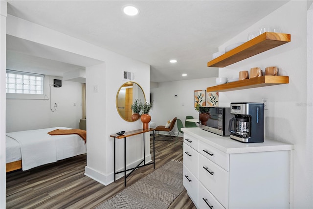 bedroom with dark hardwood / wood-style flooring