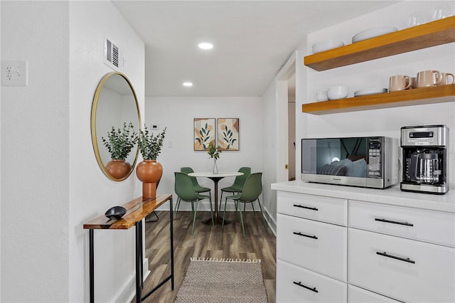 hallway with dark hardwood / wood-style floors