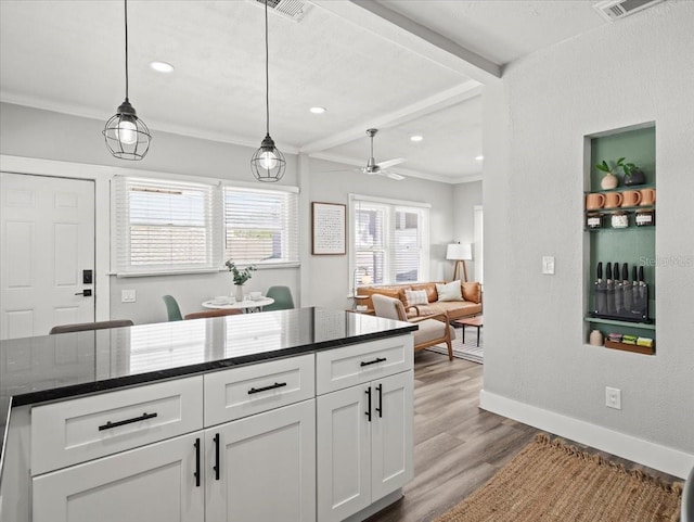 kitchen featuring pendant lighting, dark stone counters, ceiling fan, white cabinets, and light wood-type flooring