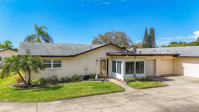 single story home with a front lawn and a garage