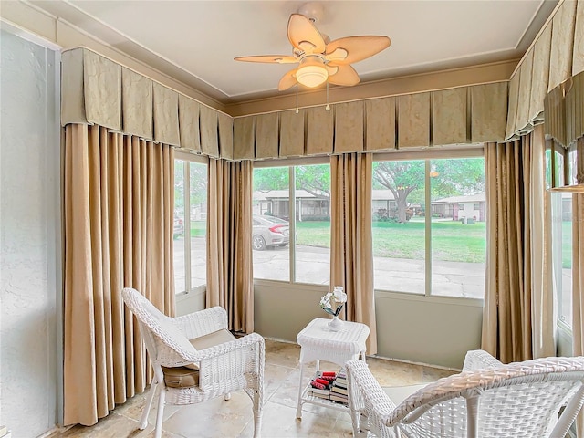 sunroom featuring ceiling fan