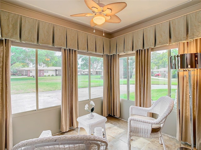 sunroom / solarium with ceiling fan and a healthy amount of sunlight