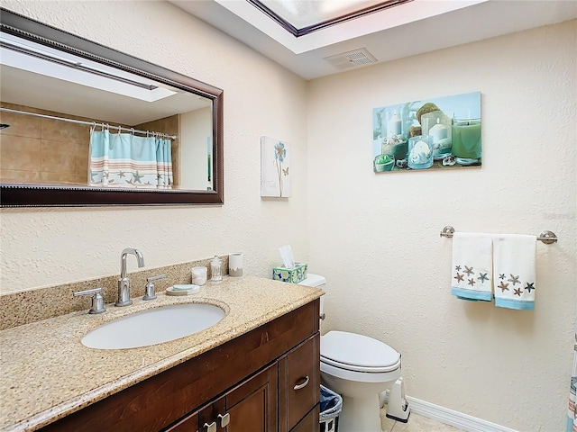 bathroom with toilet, tile floors, and oversized vanity