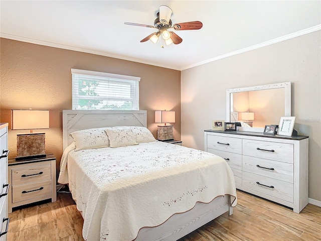 bedroom featuring crown molding, ceiling fan, and light wood-type flooring