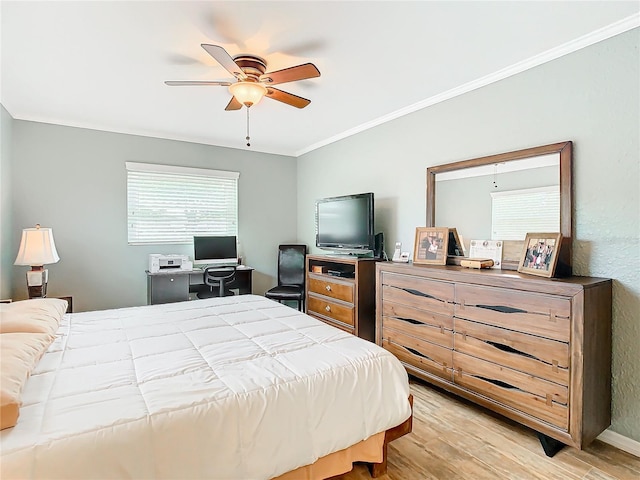 bedroom featuring ornamental molding, ceiling fan, and light hardwood / wood-style flooring