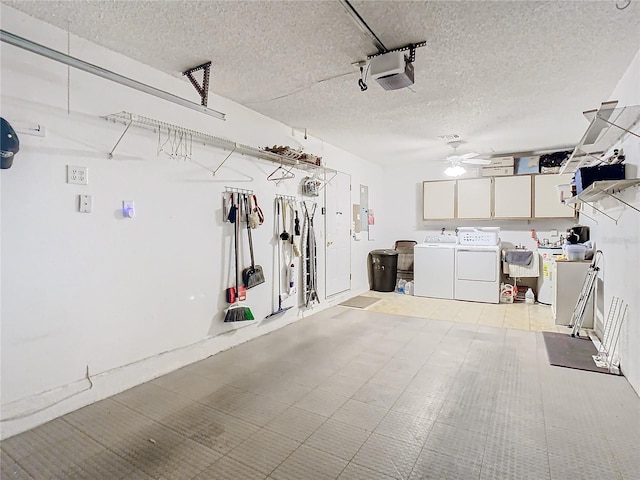 garage featuring a garage door opener, separate washer and dryer, ceiling fan, and sink