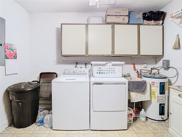 clothes washing area featuring light tile flooring, a textured ceiling, cabinets, electric water heater, and washer and clothes dryer