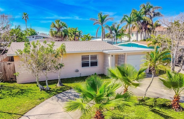 view of front of house with a garage and a front yard