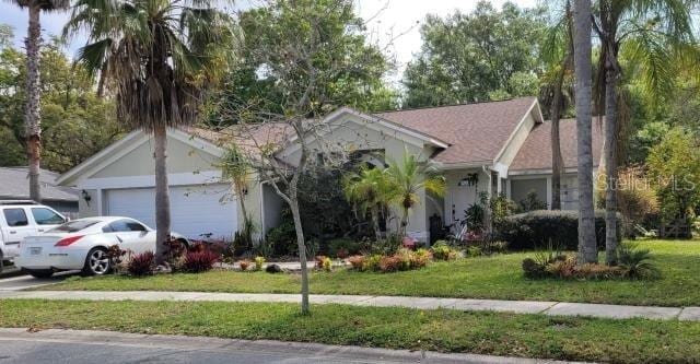 view of front of property featuring a front lawn and a garage