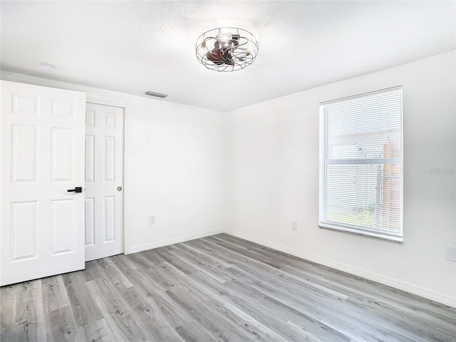 unfurnished bedroom featuring light hardwood / wood-style floors and a closet